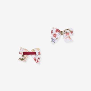 Posh Peanut Mini Bow Hair Clips - Kristiana
Two small fabric bow hair clips with a floral print on a white background, one with a burgundy elastic band and one without, shown on a light gray background.
