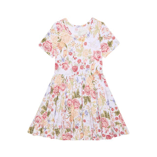 Posh Peanut Ruffled Twirl Dress - Kristiana
A short-sleeve white dress with a vintage-style floral print featuring pink, red, and yellow roses with green leaves, displayed flat against a light gray background.