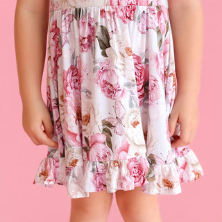 Posh Peanut Ruffled Twirl Dress - Lucienne 
Floral dress with pink flowers on a pink background