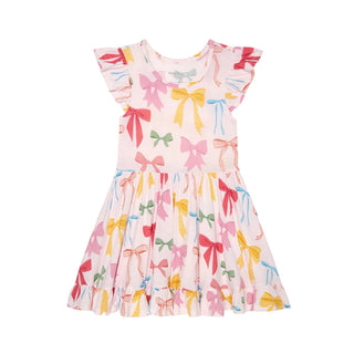 Posh Peanut Ruffled Twirl Dress - Shawna
Children's dress with colorful bow pattern on a white background
