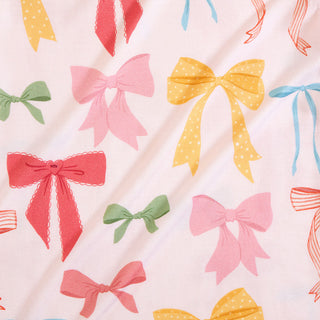 Posh Peanut Shawna
Pattern of colorful bows on a light background