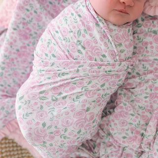 Posh Peanut Swaddle Headband Set - Annabeth 
Baby swaddled in a pink floral blanket
