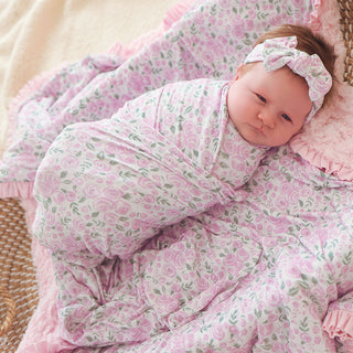 Posh Peanut Swaddle Headband Set - Annabeth
Baby wrapped in a pink floral blanket with a matching headband.