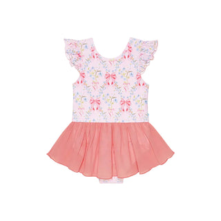 Posh Peanut Twirl Skirt Leotard - Harriet
A toddler girl's sleeveless romper dress featuring a light pink floral and bow patterned bodice with ruffle sleeves, and a contrasting coral pink tulle skirt, shown flat on a light gray background.