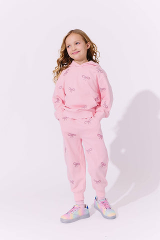 Lola and The Boys Pretty in Crystal Bows Set Young girl wearing a pink outfit with bow patterns on a white background