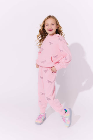 Lola and The Boys Pretty in Crystal Bows Set Young girl wearing a pink outfit with bow patterns on a white background