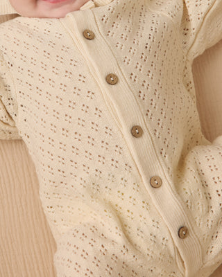 Quincy Mae Bubble Romper - Natural
Close-up of a beige baby outfit with button details