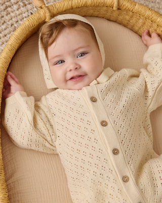 Quincy Mae Bubble Romper - Natural
Baby in a textured outfit lying in a woven basket