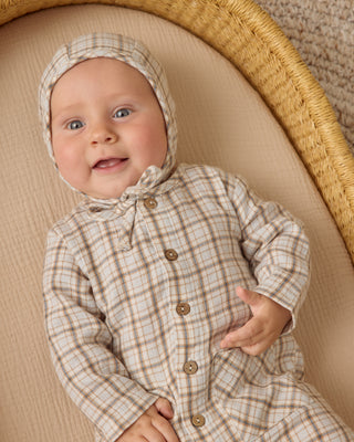 Quincy Mae Pocketed Woven Jumpsuit - Blue Plaid
Baby wearing a plaid outfit and headband, lying on a woven basket.