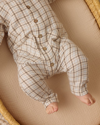 Quincy Mae Pocketed Woven Jumpsuit - Blue Plaid
Baby in a plaid outfit lying on a beige surface