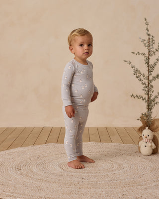 Quincy Mae Bamboo Pajama Set - Snowmen
Baby in a light gray outfit with star pattern standing on a textured rug.