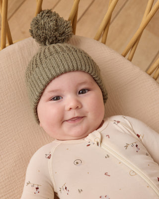 Quincy Mae Beanie - Forest
Baby wearing a green knitted hat with a pom-pom, sitting in a beige chair.