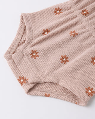 Quincy Mae pink daisy waffle cinch romper for infants with a soft fabric and adjustable waist, featuring a charming floral design.