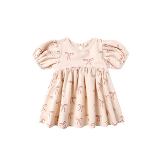Quincy Mae Darla Dress - Red Bows
Pink dress with bow pattern on a white background