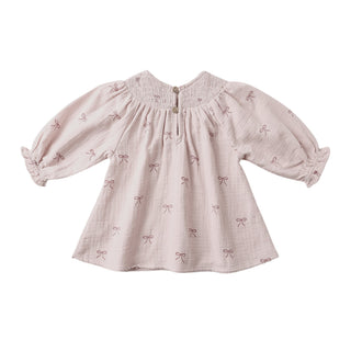 Quincy Mae V Smocked Dress - Bows
Pink dress with bow pattern on a white background