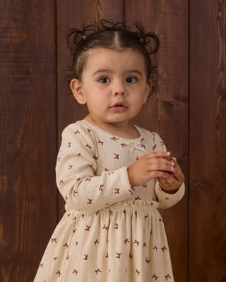 Red Quincy Mae Alda Dress with adorable bow details, perfect for young children, featuring soft fabric and a charming design.