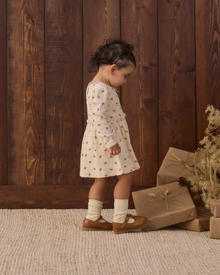 Red Quincy Mae Alda Dress featuring adorable bows, made of soft fabric perfect for little girls' special occasions.