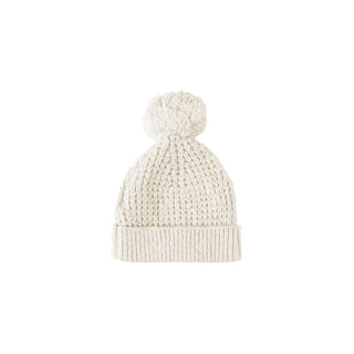White knit beanie with pom-pom on a white background