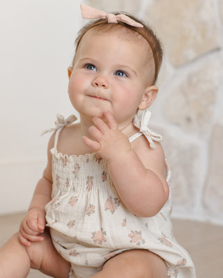 Quincy Mae Betty Romper - Garden Rose
Baby wearing a floral romper with a bow in her hair against a neutral background