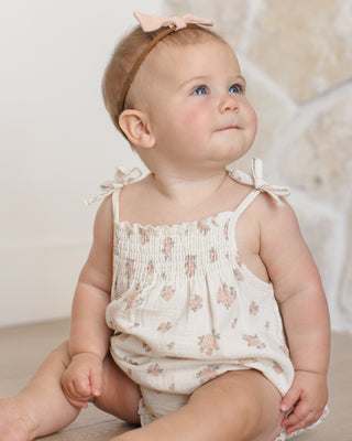 Quincy Mae Betty Romper - Garden Rose
Baby wearing a floral romper with a bow headband against a neutral background