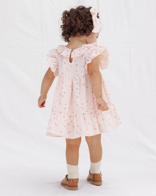 Quincy Mae Charlotte Dress - Heart Confetti
Child wearing a pink dress with ruffled sleeves on a white background