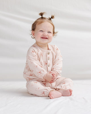 Quincy Mae Henley Bubble Jumpsuit - Swans
Baby wearing a pink floral onesie sitting on a white background