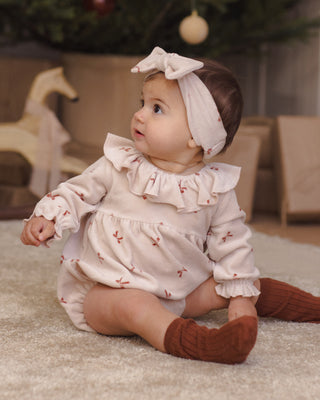 Quincy Mae Wendy romper for babies in red with bow accents, soft fabric, and adorable design for comfortable, stylish wear.