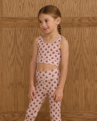 Play by Rylee & Cru Swift Sports Bra - Blush Fleur Play by Rylee & Cru Basic Legging - Blush Fleur Young girl wearing a pink floral outfit against a wooden background