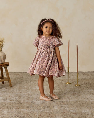 Noralee Luna Dress - Harvest Fleur
Young girl in a floral dress standing in a room with candles and a vase.