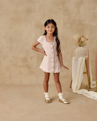 Noralee Gabrielle Dress - Rose
Young girl in a light dress standing against a beige background