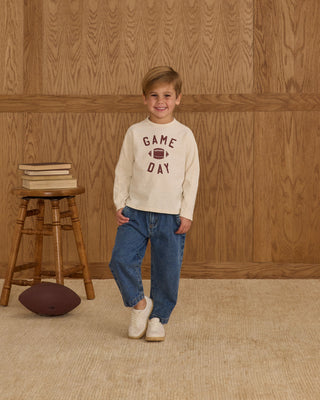 Rylee & Cru Long Sleeve Paneled Tee - Game Day
Child wearing a 'Game Day' sweater standing in front of a wooden wall with a stool and football.