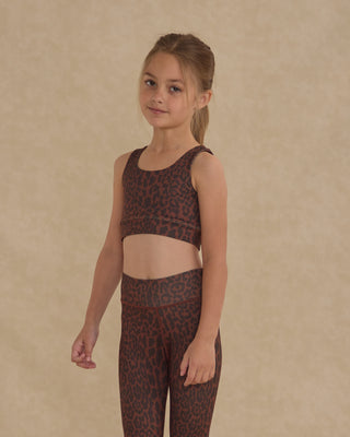 Play by Rylee & Cru Swift Sports Bra - Leopard
Young girl wearing a leopard print sports bra and leggings against a beige background