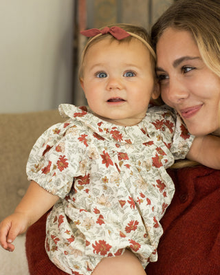 Rylee & Cru Lula Romper - Holiday Floral
Woman holding a baby wearing a floral outfit indoors