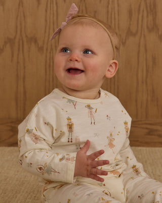 Rylee & Cru Henley Jumpsuit - Nutcracker
Baby wearing a patterned outfit with a wooden background