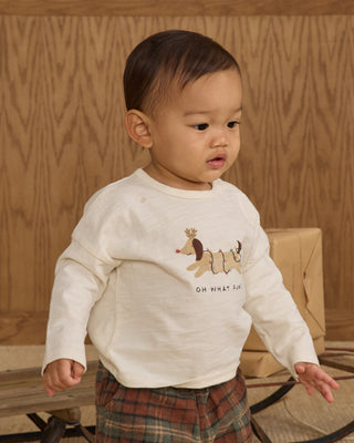 Rylee & Cru Long Sleeve Tee - Oh What Fun
Child wearing a white sweatshirt with a graphic design and text, standing against a wooden background.