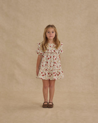 Rylee & Cru Cordelia Dress - Holiday Floral
Young girl wearing a floral dress against a beige background