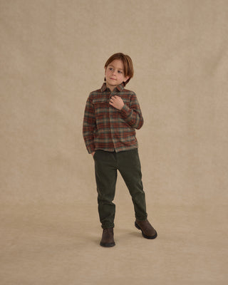 Rylee & Cru Pocketed Flannel Shirt - Holiday Plaid
Child wearing a plaid shirt and green pants on a beige background