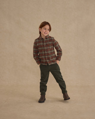 Rylee & Cru Pocketed Flannel Shirt - Holiday Plaid
Child wearing a plaid shirt and green pants on a beige background