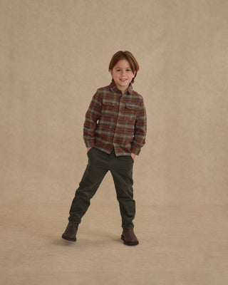 Rylee & Cru Pocketed Flannel Shirt - Holiday Plaid
Child wearing a plaid shirt and green pants on a beige background