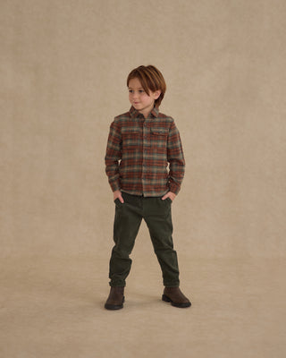 Rylee & Cru Pocketed Flannel Shirt - Holiday Plaid
Child wearing a plaid shirt and green pants standing against a beige background