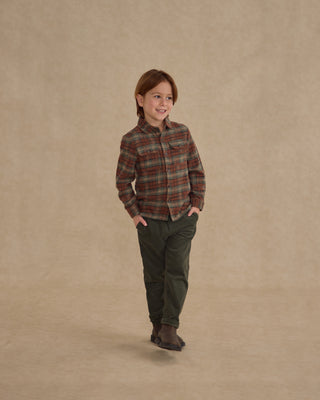 Rylee & Cru Pocketed Flannel Shirt - Holiday Plaid
Child wearing a plaid shirt and green pants on a beige background