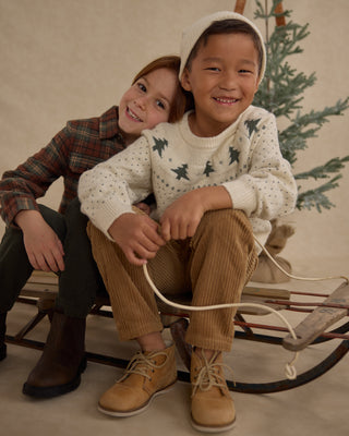 Rylee & Cru Fairisle Sweater - Trees
Two children sitting on a sled with a Christmas tree in the background