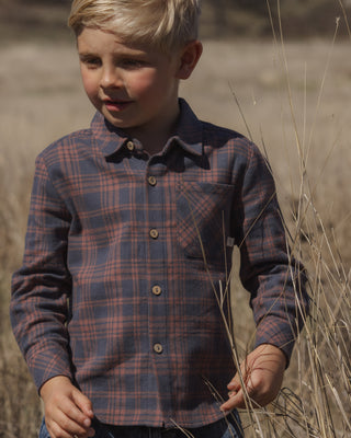 Rylee & Cru Collared Long Sleeve Shirt - Midnight Plaid
A young boy wearing a long-sleeve button-up plaid shirt in navy and red, standing in a dry grassy field.