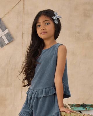 Rylee & Cru Faye Set - Marine
Young girl wearing a blue dress with a textured background