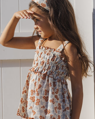 Rylee & Cru Smocked Tank - Americana Floral
Young girl wearing a floral dress with a white background