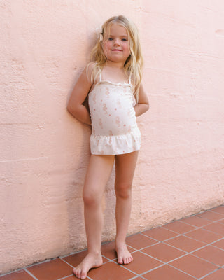 Rylee & Cru Tori Swimsuit with seahorse print, featuring a skirted one-piece design, shown in a lifestyle setting.