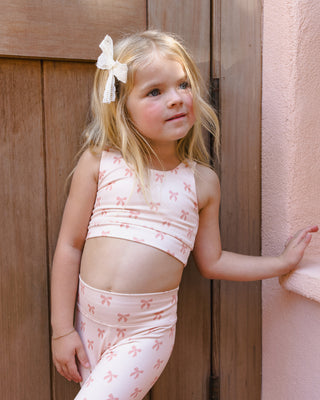 Play by Rylee & Cru Swift Sports Bra with bows, shown in a lifestyle setting, featuring a comfortable fit and stylish design.