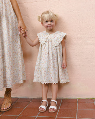Rylee & Cru Porter Dress in Summer Garden print, featuring a lightweight, floral dress worn by a girl in a garden setting.