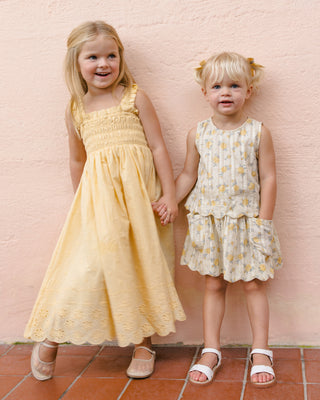 Rylee & Cru Hanna Dress in Lemon, a lightweight floral dress for girls with ruffle details and bright yellow color.