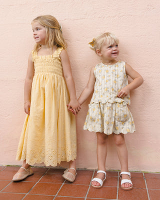 Rylee & Cru Hanna Lemon Dress for girls, featuring a bright yellow fabric and playful design, worn by a child in a lifestyle setting.